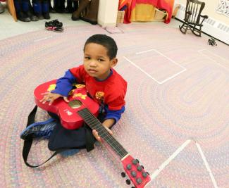 A child with a toy guitar